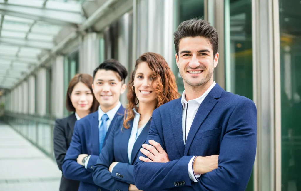 A group of business professionals in formal attire discussing financial strategies and project funding in a corporate meeting room.