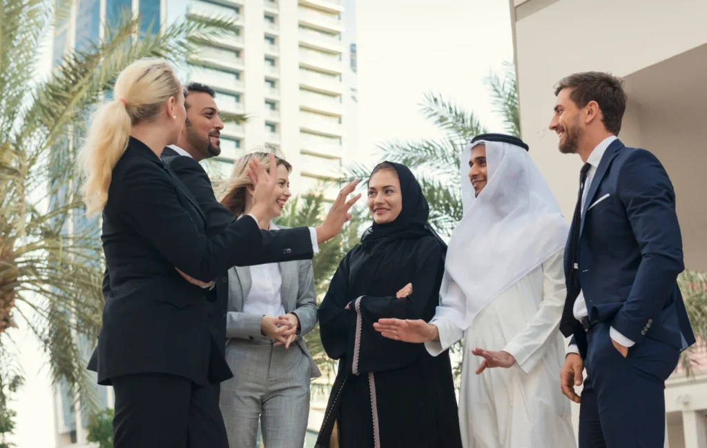 Business consultants discussing market insights and strategies at a Dubai management consultancy office.